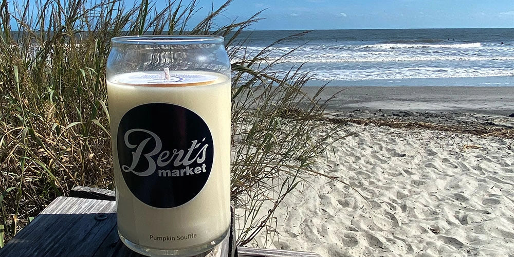 Bert's Market candle on a beach with ocean view
