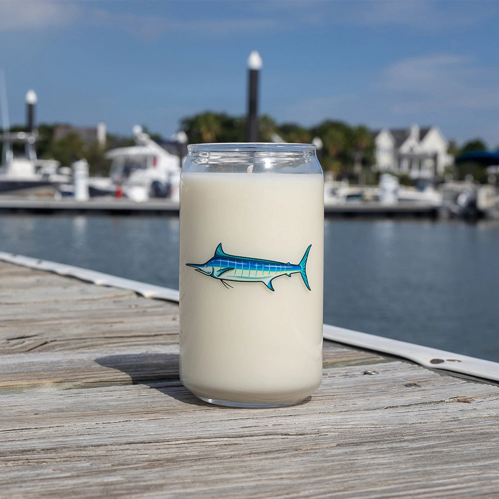 Glass with a fish design on a dock by a marina