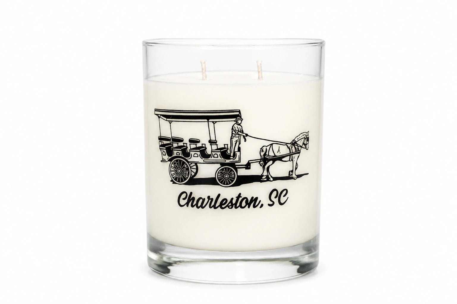 A white wax candle in a clear glass jar with two wicks, featuring a black graphic of a horse-drawn carriage and the text 'Charleston, SC' on the front, set against a plain white background.