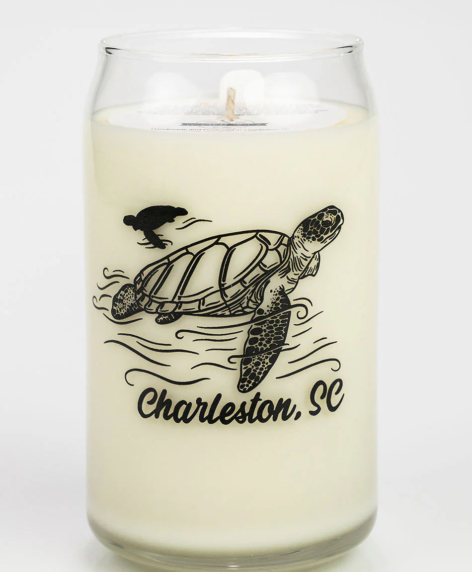 Candle with a turtle design and 'Charleston, SC' text on a white background