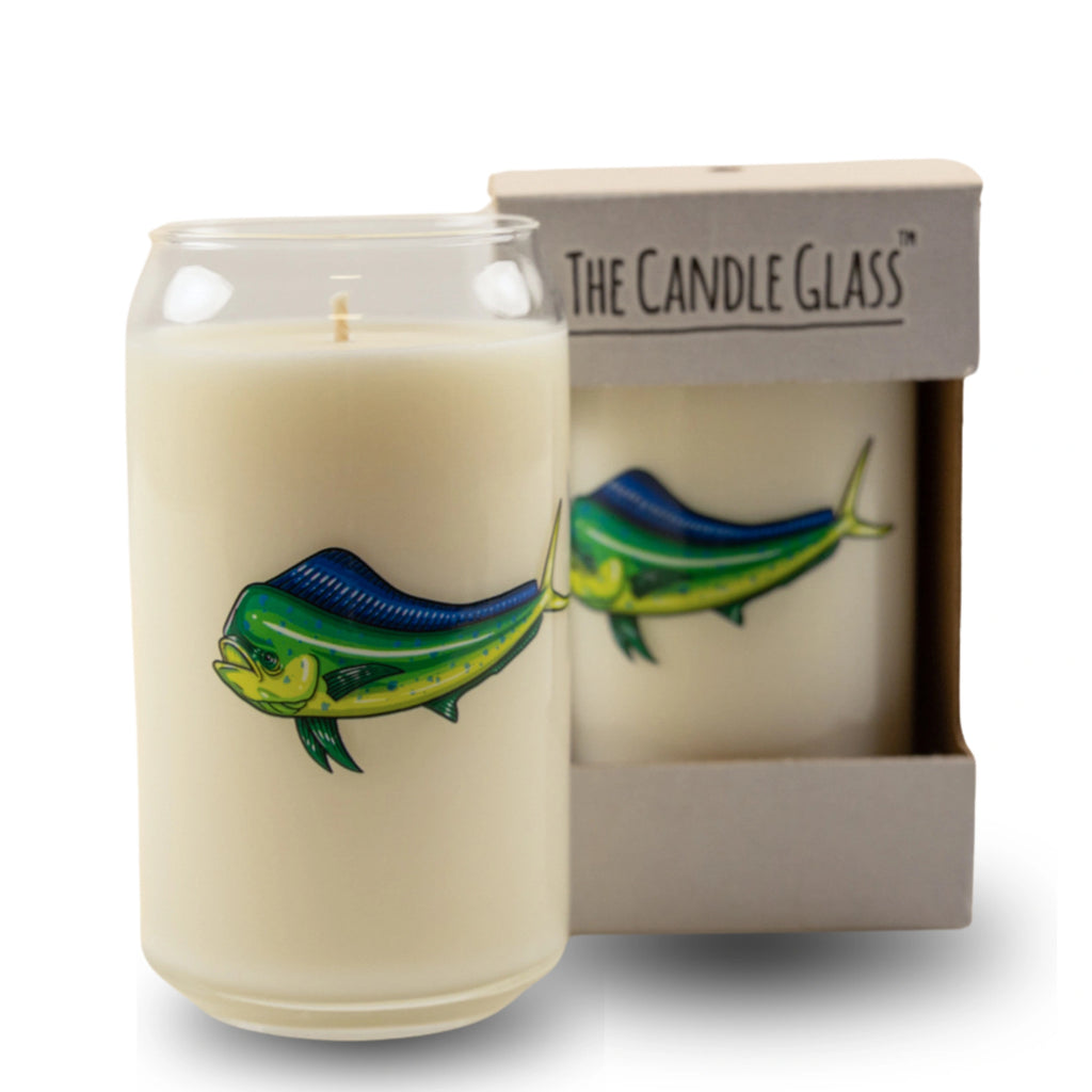 Candle with fish design in a glass container next to its packaging box on a white background