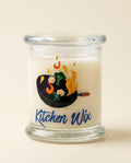 Glass candle with 'Kitchen Wix' branding and design on a beige background