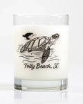 Candle with a turtle design and 'Folly Beach, SC' text on a white background
