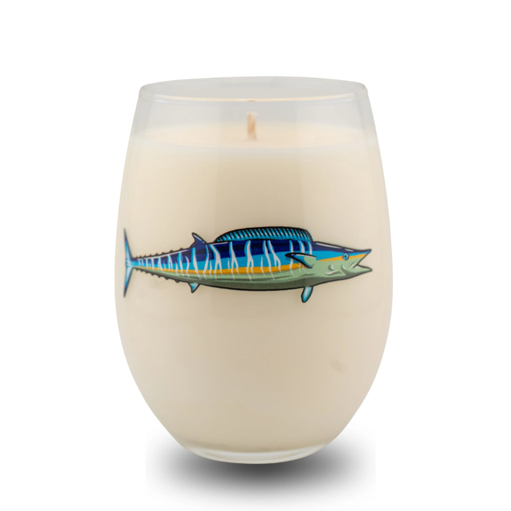 Candle in a glass container with a fish design on a white background