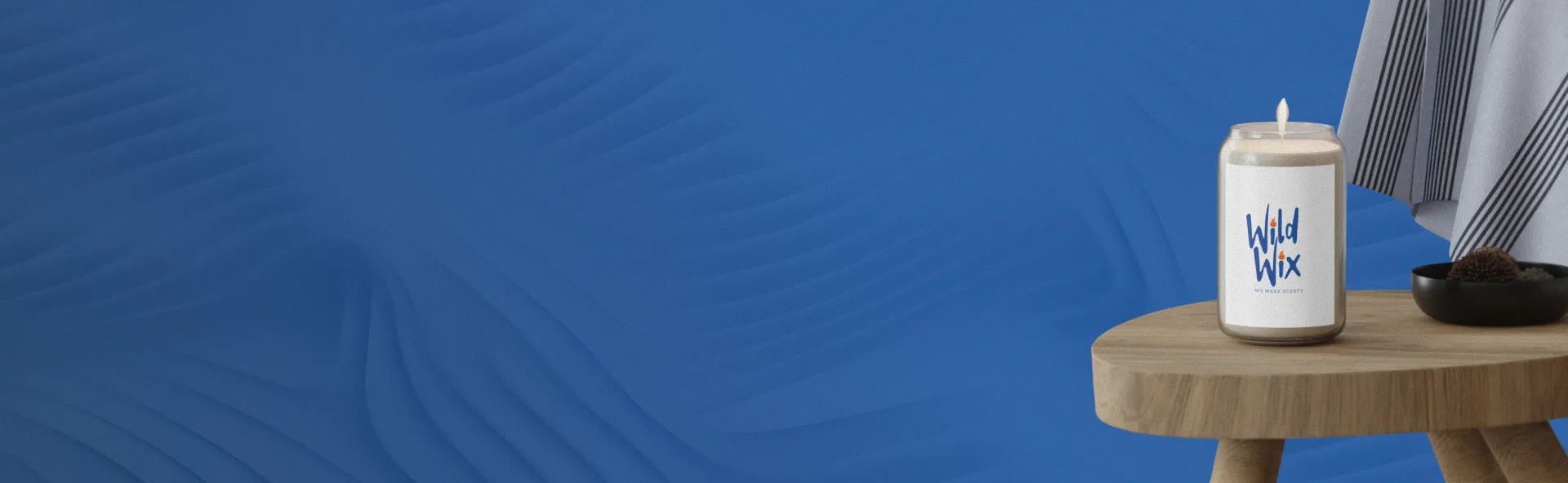 Candle on a wooden table with a blue background