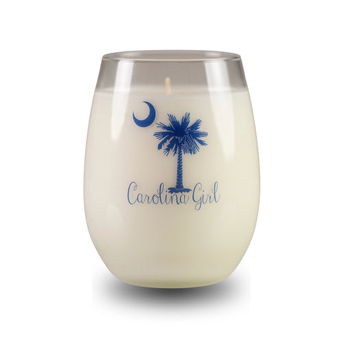 White candle in a glass container with blue 'Carolina Girl' design on a white background